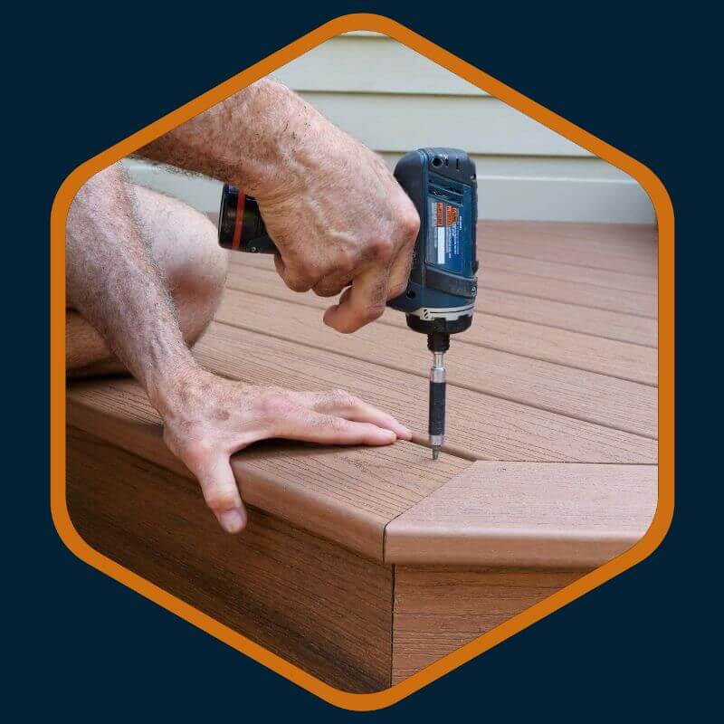 Technician's hand drilling a screw into a deck during repairs by Kairos Upholstery in Bryanston.