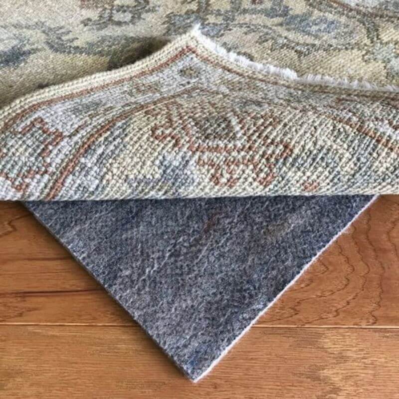 A rolled Persian rug with a premium underfelt sold by Kairos Upholstery, showcasing high-quality underfelt options in Pretoria.