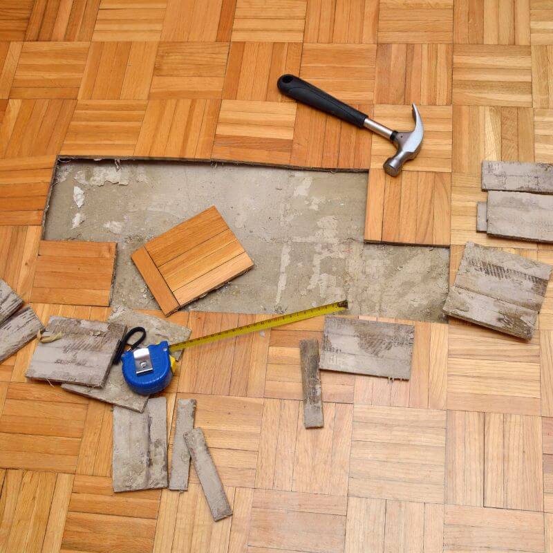 A wooden floor being expertly repaired by Kairos Upholstery, showcasing professional wooden floor repairing services in Pretoria.